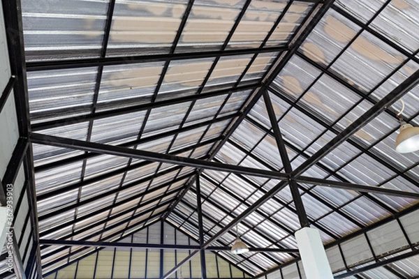 Obraz Steel roof structure. Moonlight bulb. Steel structure with roof tiles. Architectural structure of roof. Large roof layout used for industrial plants.