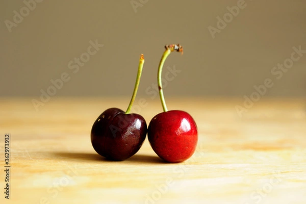 Fototapeta Close up of two cherries on the wooden table