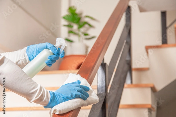 Fototapeta Deep cleaning for Coronavirus disease prevention. alcohol,disinfectant spray on Wipes of Banister in home for safety,infection of Covid-19 virus,contamination,bacteria that are frequently touched