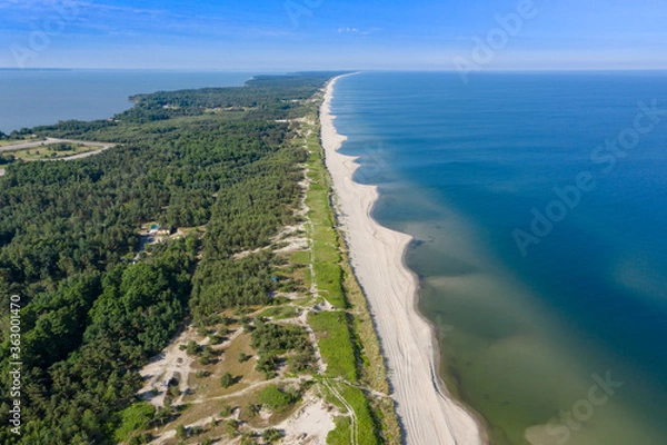 Fototapeta Beautiful view from the top of the Baltic (Vislin) spit. The sandy beach washed by the Baltic sea goes into the distance. Shot on a drone.