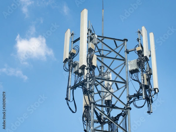 Fototapeta LTE, GSM, 2G, 3G, 4G, 5G tower of cellular communication. Telecommunication tower against the blue sky with clouds.