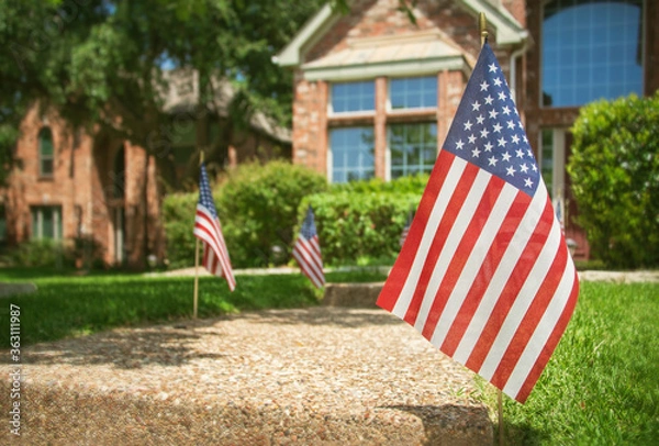 Obraz American flags displayed in the front of a southern home in honor of the 4th of July