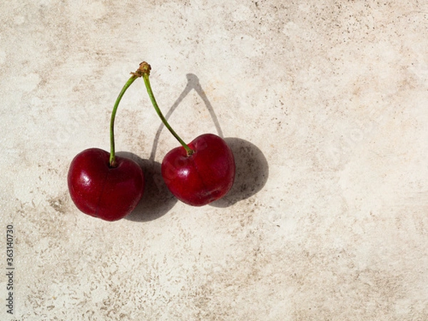 Obraz two cherries close up on beige background