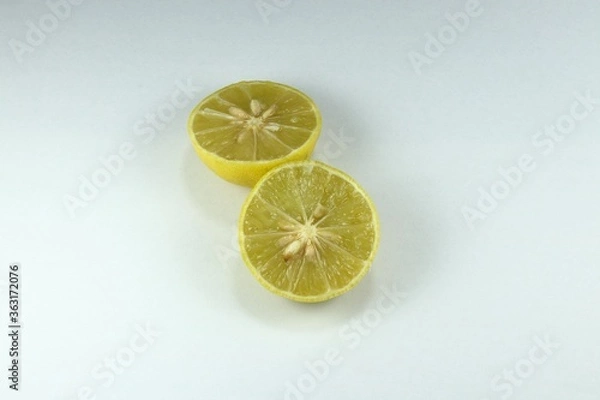 Fototapeta Cutting ripe organic lime with seed on the white background. Main ingredients in Asia cooking food and beverage, sour taste. 