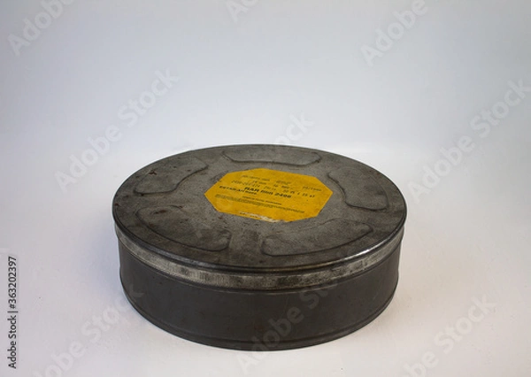 Obraz An original old film can with an orange label. For 16 mm film rolls.