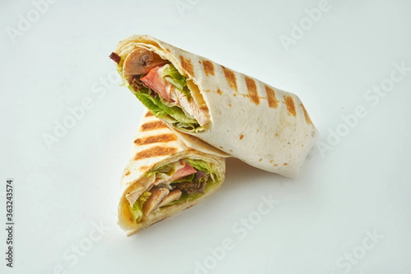 Fototapeta Fresh roll with chicken, tomatoes, cheese and lettuce in pita bread on a white background. Baked Chicken Shawarma