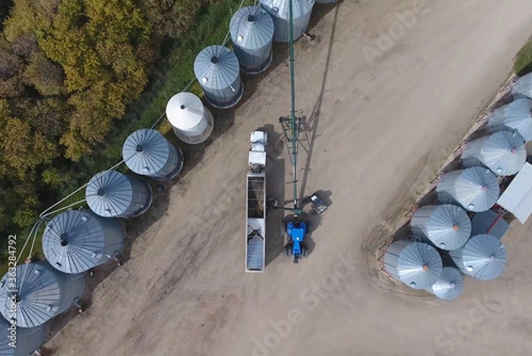 Obraz aerial view loading grain harvester into haulage track farming agriculture