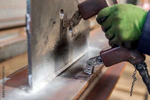 Fototapeta Magnetic particle inspection. The magnetizing pulse is applied for 0.5 seconds, during which the operator washes the part with the particle, stopping before the magnetic pulse is completed.