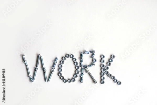 Fototapeta The inscription is the word work lined with bolts and nuts. Bolts and nuts on a white background.