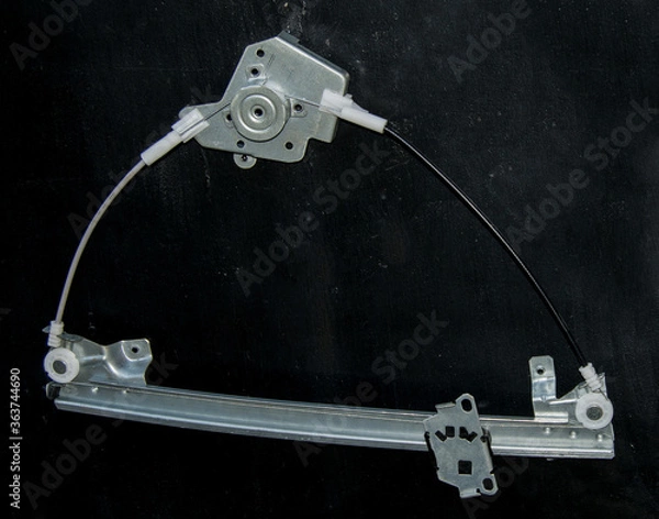 Fototapeta The mechanism of the electric window lifter of a car close up