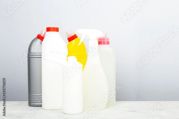 Fototapeta Various detergents and cleaning products agent, gray background. Copy space