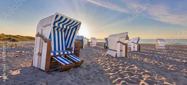 Fototapeta Sunset at calm beach with beach chairs 