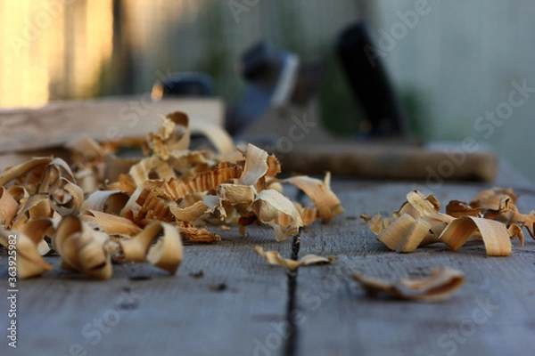 Fototapeta view of the desktop in the carpenter's shop. Wood shavings and carpenter's tools