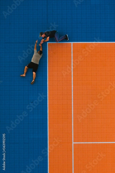 Fototapeta White man helping Mexican man viewed in a creative manner showing that color does not matter that all life is important.  Racism does not exist. Civil-rites.  No color.  Equality.  Taking a stand.  