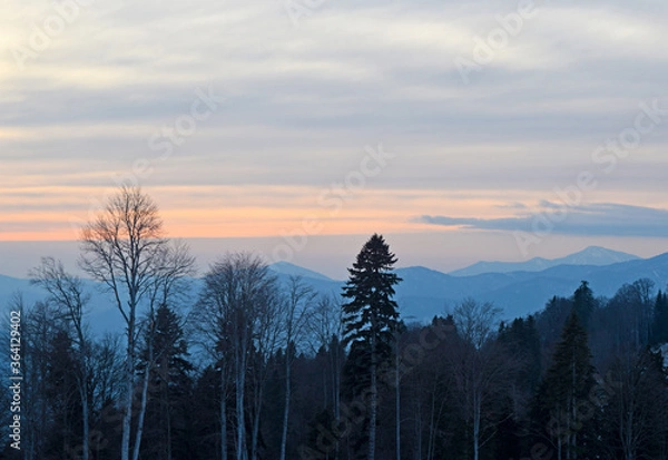 Obraz Colorful clouds over the mountains and the forest