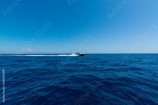 Fototapeta Expensive speedboat running over the guf of Naples.