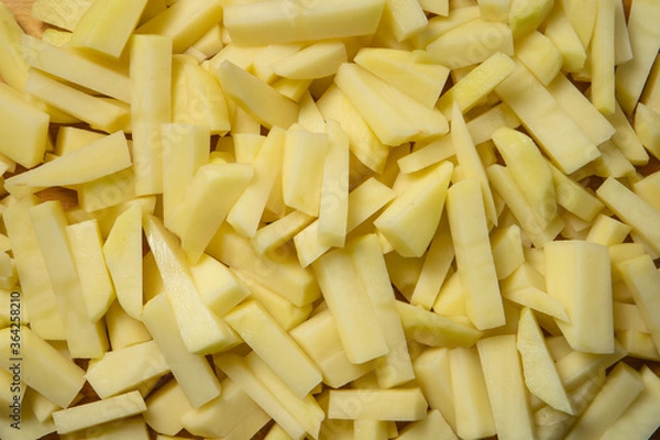Obraz Freshly sliced rectangular pieces of potato, close-up. cooking potatoes.