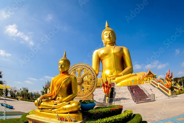 Fototapeta Beautiful of Large golden sitting Buddha statue with background of blue sky at Wat Muang  temple ,Ang Thaong,Thailand