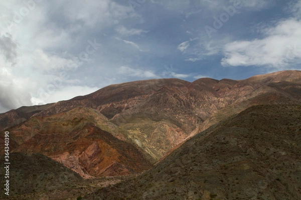 Fototapeta Geology. Desolated landscape. The brown and arid mountains under a beautiful sky.