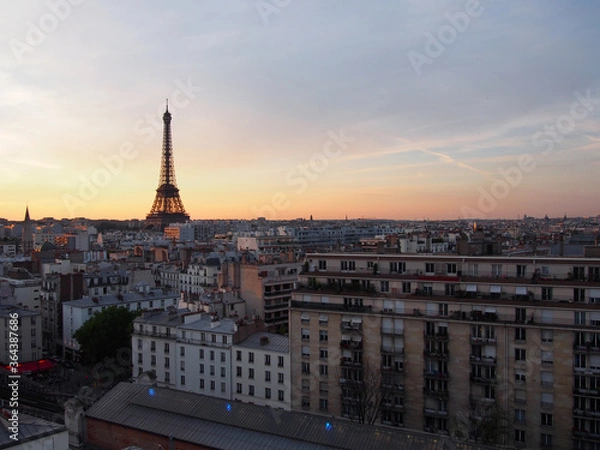 Fototapeta Paris skyline with an impressive Eiffel Tower in the pleasant sunset sky.