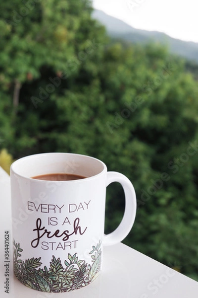 Obraz Coffee mug with inspirational message with nature background. Every day is a fresh start. Copy space.