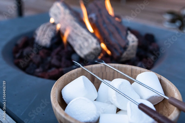 Fototapeta Roasting marshmallow over a gas fire while glamping