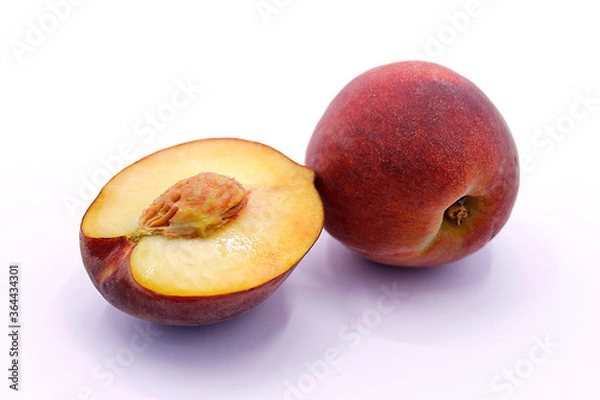 Fototapeta Sliced peach, whole peach close-up on a white background