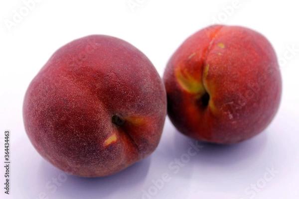 Fototapeta Two ripe red peaches closeup isolated on white background