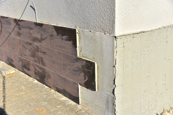 Obraz Insulation of walls cladding a ceramic tile. Modern metal facade tiles to repair and restore front side of building. Сomposite panels, resource conservation, material.