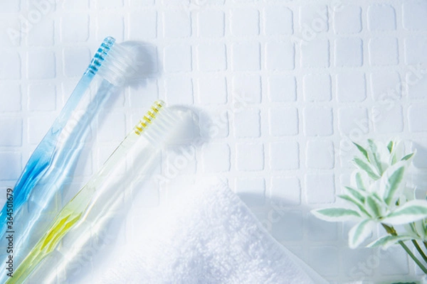 Fototapeta 歯ブラシが2本とタオル。歯磨きなど歯のケア、生活・日常のイメージ。