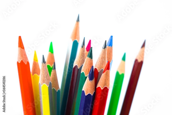 Fototapeta A huge pile of different colored wood pencil crayon placed on a white background