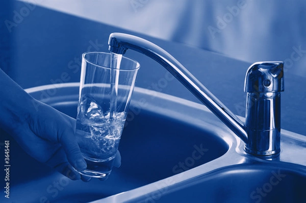 Obraz Pouring Fresh Tap Water Into a Glass. Shallow DOF. Focus on Tap.