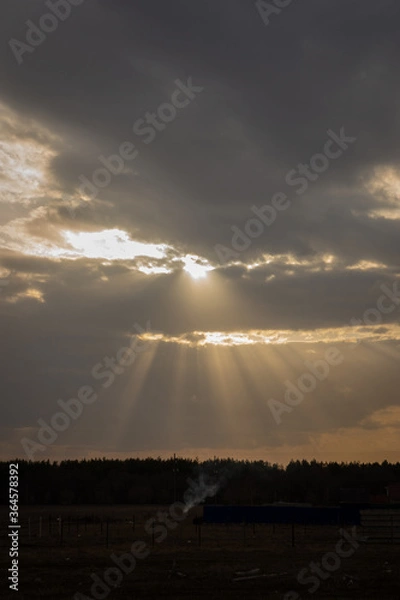 Fototapeta sunrays through clouds
