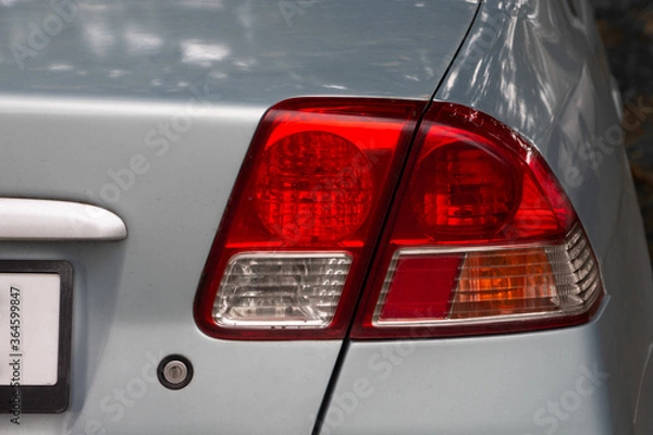 Fototapeta Close up of rear taillight on a grey vehicle