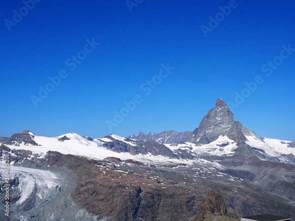 Fototapeta Matterhorn seen from the mountain climbed by the train in Zermatt on a sunny day.