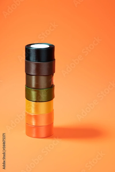 Fototapeta colored packing tape in rolls on colored background