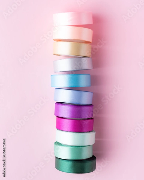 Fototapeta colored packing tape in rolls on colored background