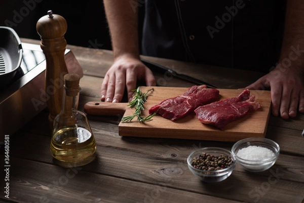 Fototapeta the chef is about to marinate the beef steak