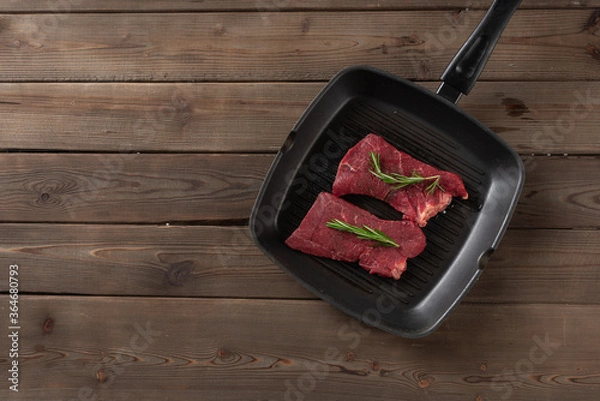 Fototapeta raw beef steaks in a pan