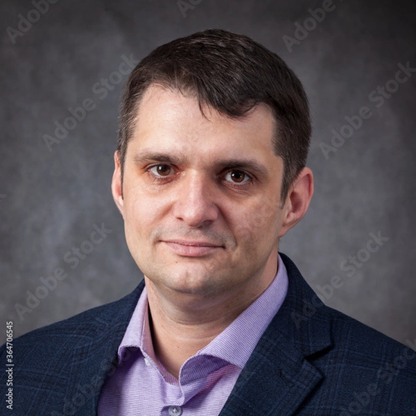 Obraz a young man businessman on a plain background.