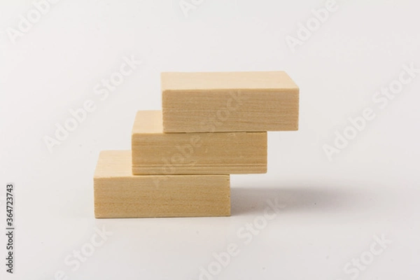 Fototapeta stairs concept; toy wood blocks make a stairs isolated on white background with copy space for your text