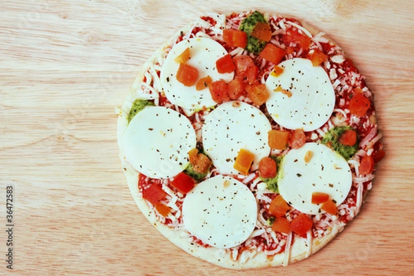 Fototapeta top view of a frozen pizza
