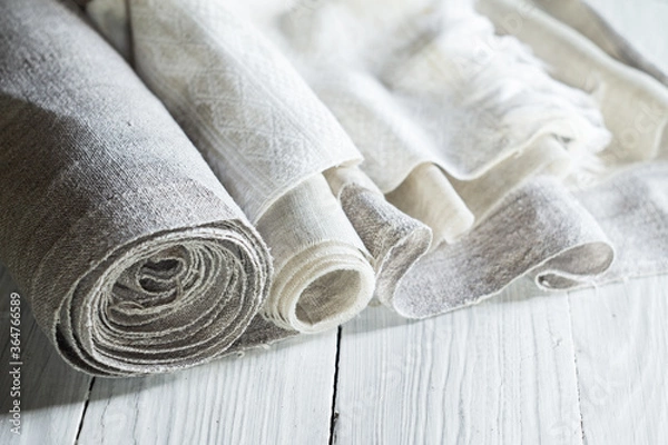 Fototapeta Old homespun and modern factory linen fabrics in rolls