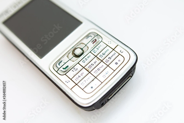 Fototapeta old push-button smartphone on a white background