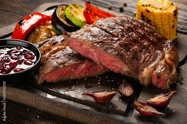 Obraz Medium Rare Ribeye steak on wooden board