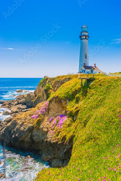 Fototapeta Pigeon Point Lighthouse, Landmark of Pacific Coast Highway (Highway 1) at Big Sur, surrounded with colorful wildflowers in spring time, California