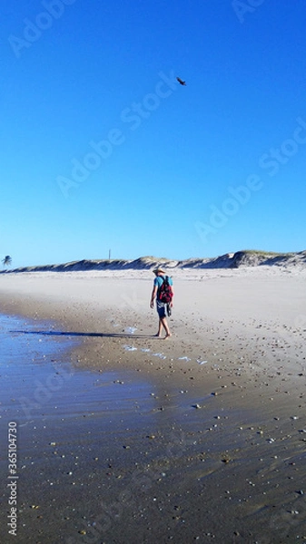 Fototapeta man walking on the beach