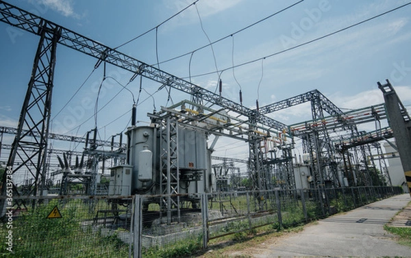 Fototapeta Electrical Transformer. Distribution of electric energy at a big substation with lots power lines