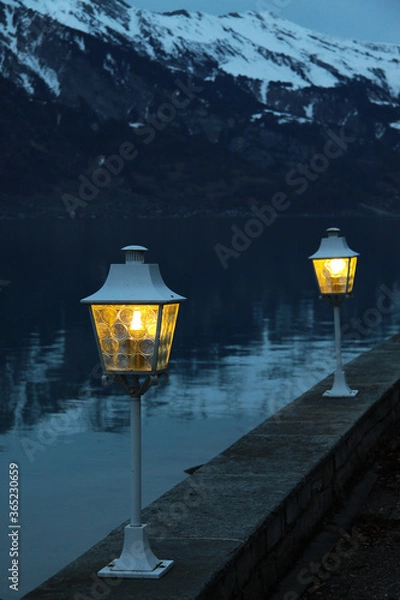 Fototapeta Lanterns on the shore of a mountain lake