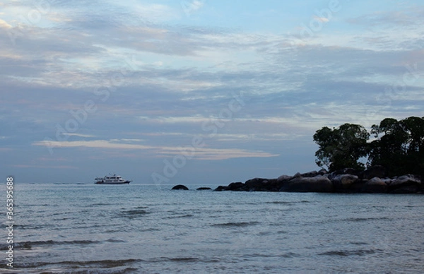 Fototapeta View of dawn at the seaside with the dramatic sky, boat and mountain, Tioman Island